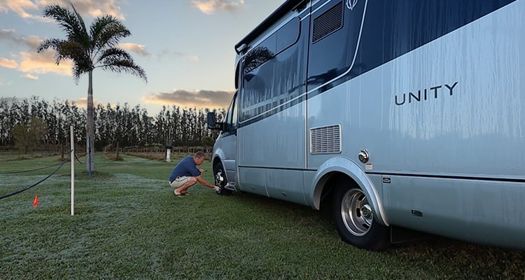 Checking tires on a Leisure Travel Vans Unity FX